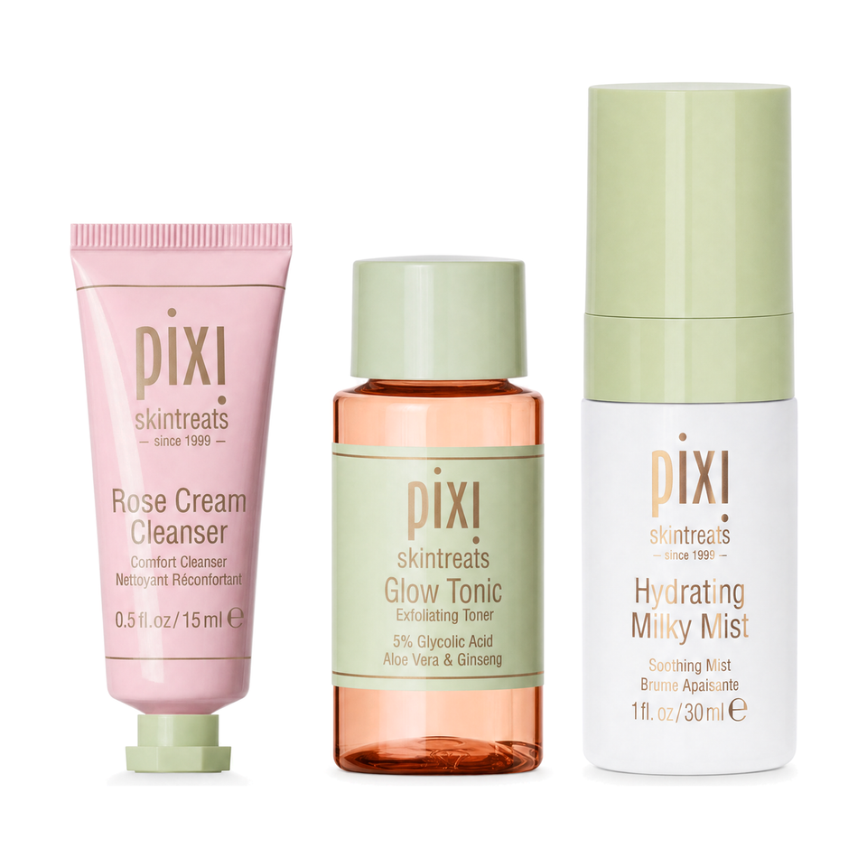 Three Pixi Skintreats skincare bottles and tubes arranged side by side on a white background: a pink Rose Cream Cleanser tube, an amber Glow Tonic bottle with a pale green cap, and a white Hydrating Milky Mist bottle with a pale green cap. view 1