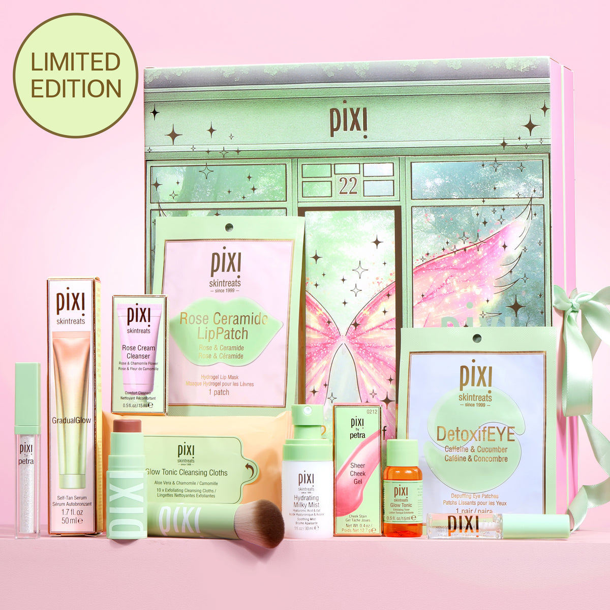 Pixi Advent Calendar set on a pink background, featuring a mint green fairy-themed box with multiple skincare products including lip patch, eye cream, cleanser, and toner.