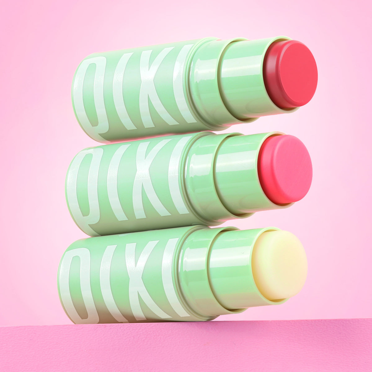 +Hydra LipTreat Trio three product shades shown on pink background.