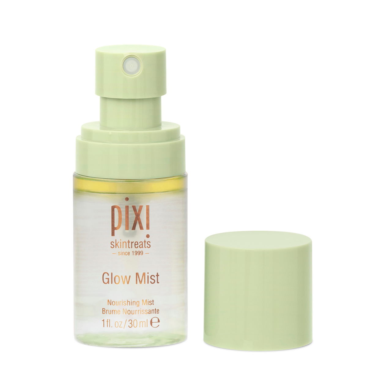 Pixi Skintreats Glow Mist nourishing spray bottle in a pale sage green color, shown with its cap off next to it on a white background.